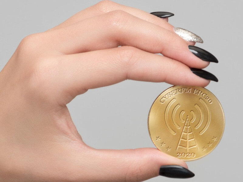 CyberFM hand holding coin